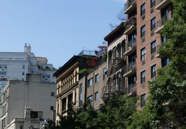 A mix of NYC residential buildings and blue sky